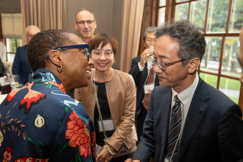 Pres. Claudine Gay shakes hands with Tohoku University Vice-President Masahiro Yamaguchi