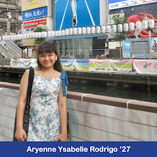 Student standing in front of a cityscape.