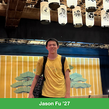 Young man standing under Japanese lanterns