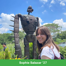 Young woman standing in front of a robot statue